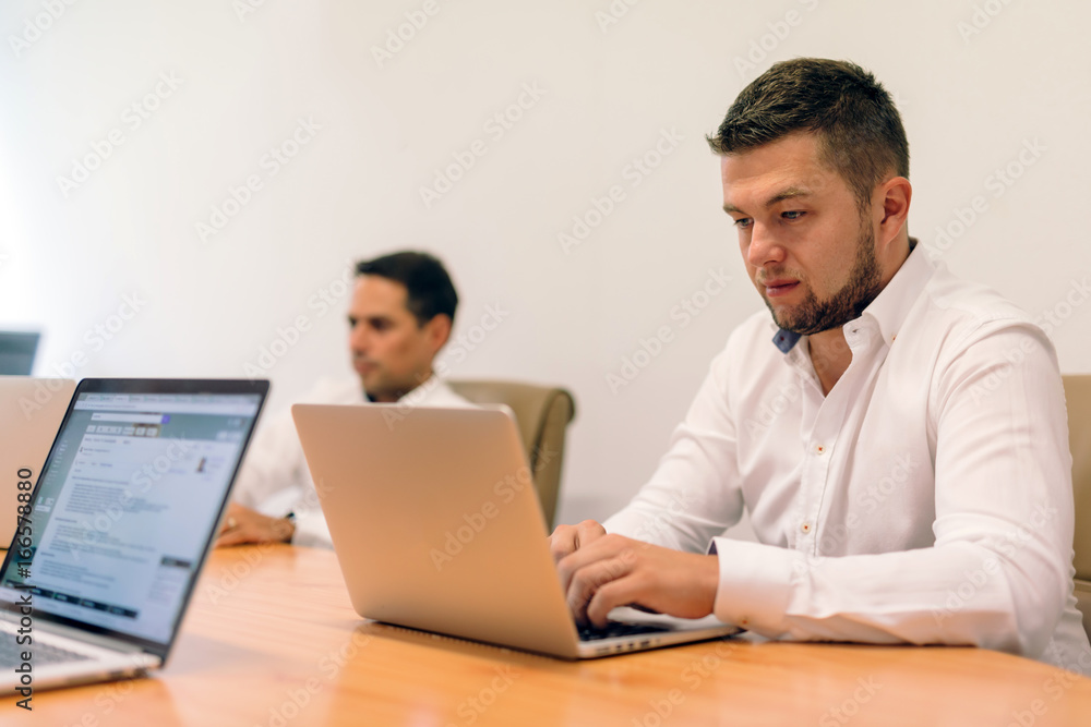 People working on laptops in office People working on laptops in office