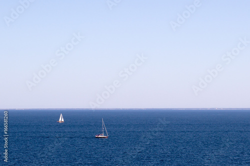 Two sailboats on a blue sea © Bogdan