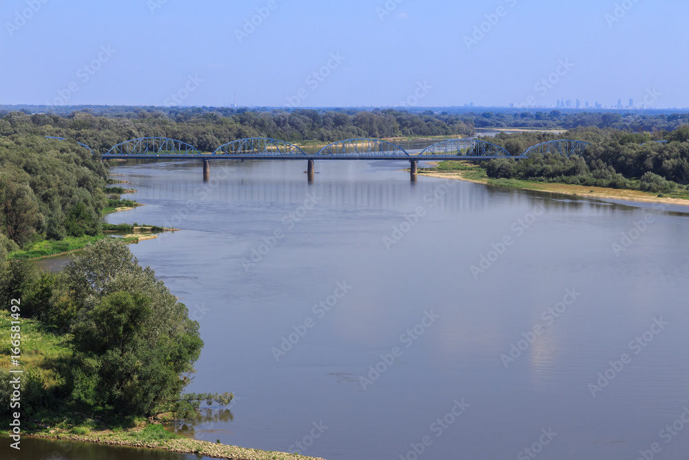 Old bridge on Vistula river near Modlin Fortress (Twierdza Modlin), located in  Nowy Dwor Mazowiecki,50 km north of Warsaw. In background visible warsaw scyscrapers

