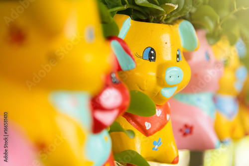 Colorful animal ceramic doll hanging in the garden.