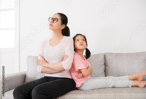 beautiful mother and daughter sitting together