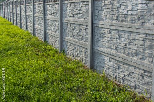 Decorative stone fence with green grass
