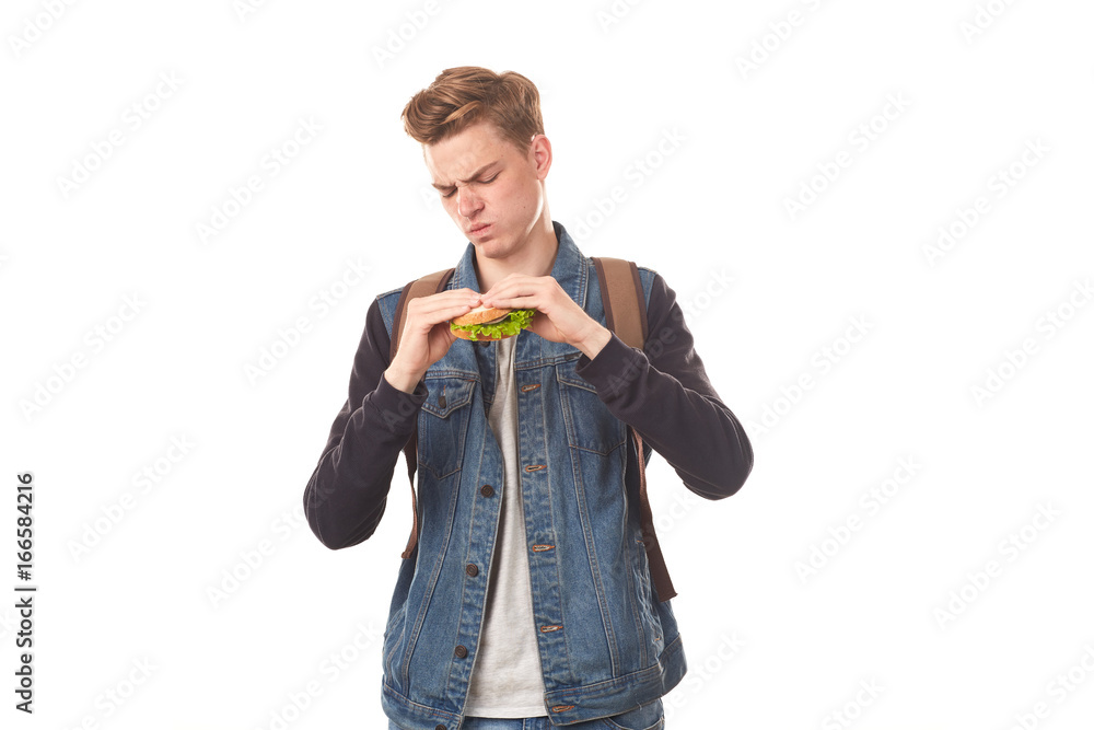 Portrait of student feeling disgust after eating rotten sandwich Portrait of student feeling disgust after eating rotten sandwich