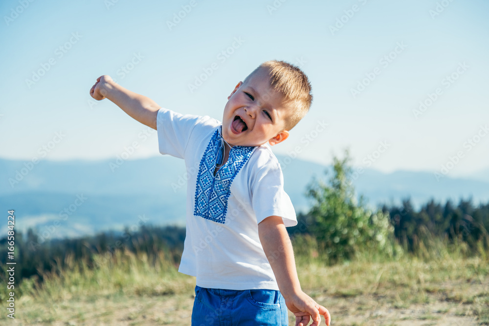 little boy playing on the top of the mountain little boy playing on the top of the mountain