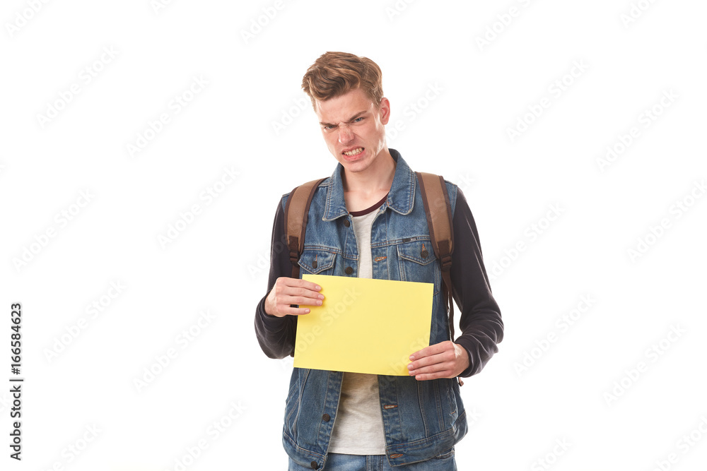 Portrait of schoolboy posing with blank paper against white background Portrait of schoolboy posing with blank paper against white background