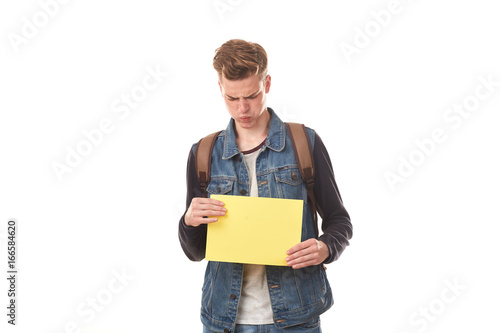 Portrait of schoolboy posing with blank paper against white background