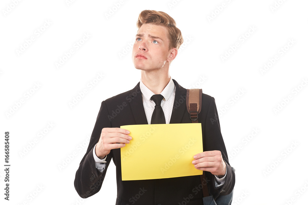 Handsome college student posing in studio with blank paper sheet Handsome college student posing in studio with blank paper sheet