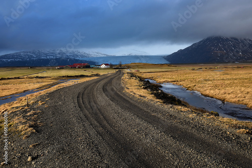 Icelandic landscape,Empty long asphalt road perspective leading to snow covered mountains, Beautiful nature landscape in early winter of Iceland