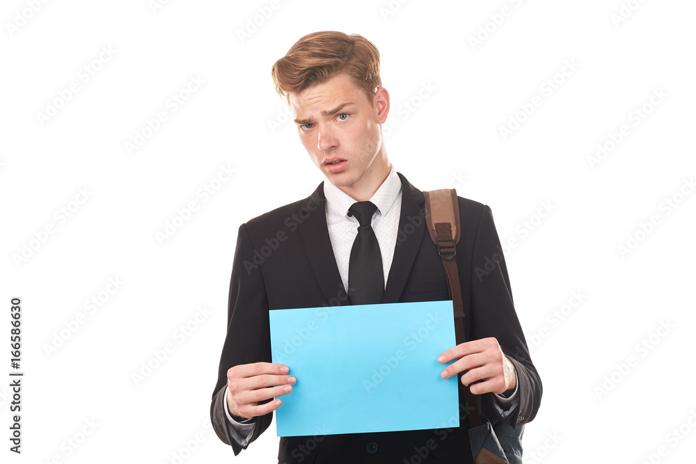 Handsome college student posing in studio with blank paper sheet Handsome college student posing in studio with blank paper sheet