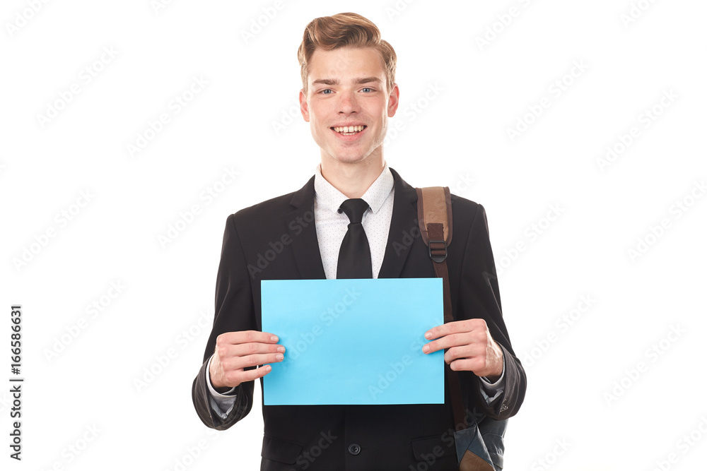 Handsome college student posing in studio with blank paper sheet Handsome college student posing in studio with blank paper sheet