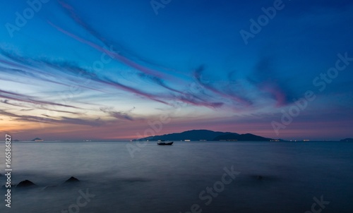 Sunrise sky Nha Trang Vietnam cloudy blue orange red sky over the south china sea long exposure.