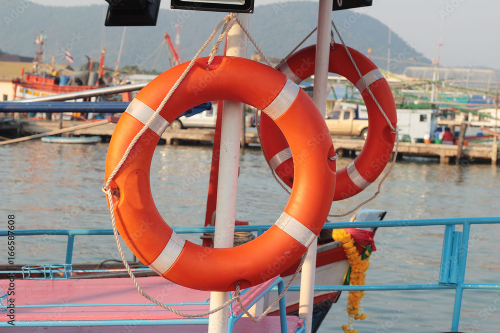 Ring buoy on the boat with the ocean
