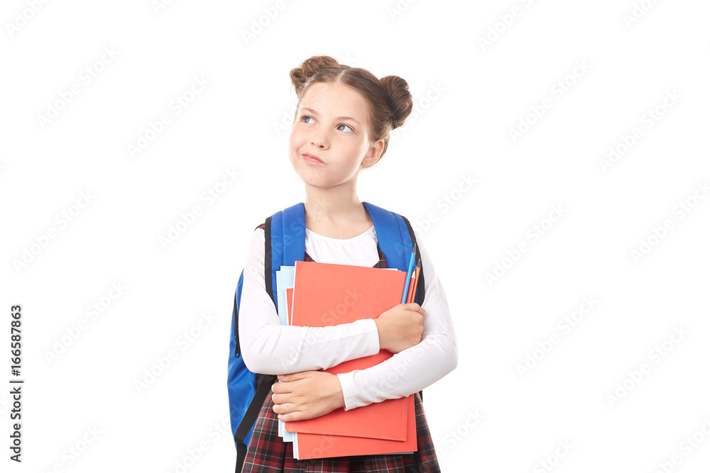 Portrait of girl in school uniform with backpack holding textbooks and pencils and creating ideas against white background Portrait of girl in school uniform with backpack holding textbooks and pencils and creating ideas against white background