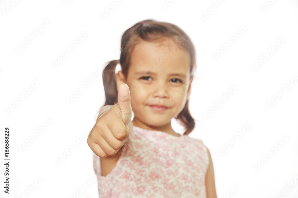 Little girl making thumbs up on white background. Little girl making thumbs up on white background.
