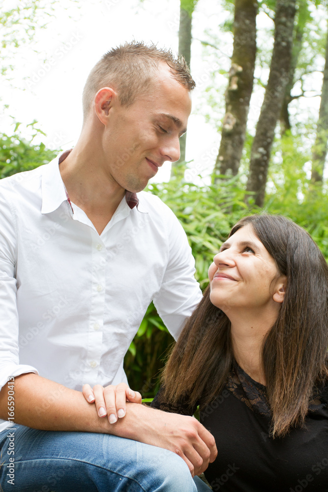 Happy loving couple embracing outdoors at summertime under blue sky Happy loving couple embracing outdoors at summertime under blue sky