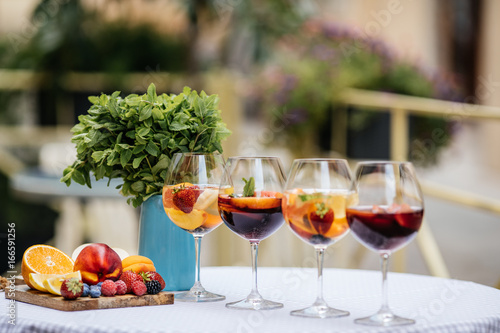 Delicious Red Sangria with fruits on table