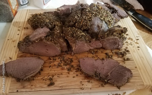 Billede på lærred Sliced venison roast on cutting board