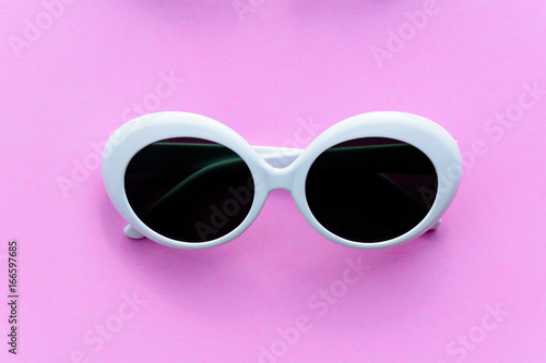 Flat lay fashion style sunglasses on colorful background