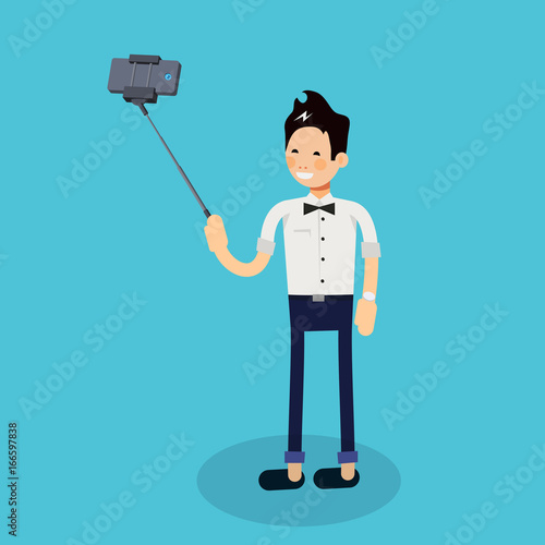 young cute man standing full length trying to make a self portrait with mobile device using selfie stick