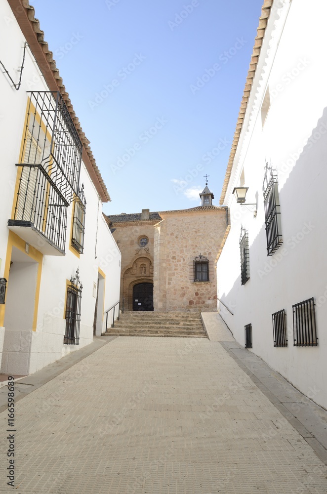 Church at street in Belmonte, Castile, Spain