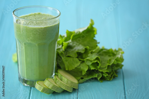 Glass with fresh tasty vegetable smoothie on table