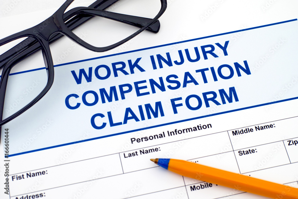 Work Injury Compensation Claim Form with pen and glasses. Work Injury Compensation Claim Form with pen and glasses.