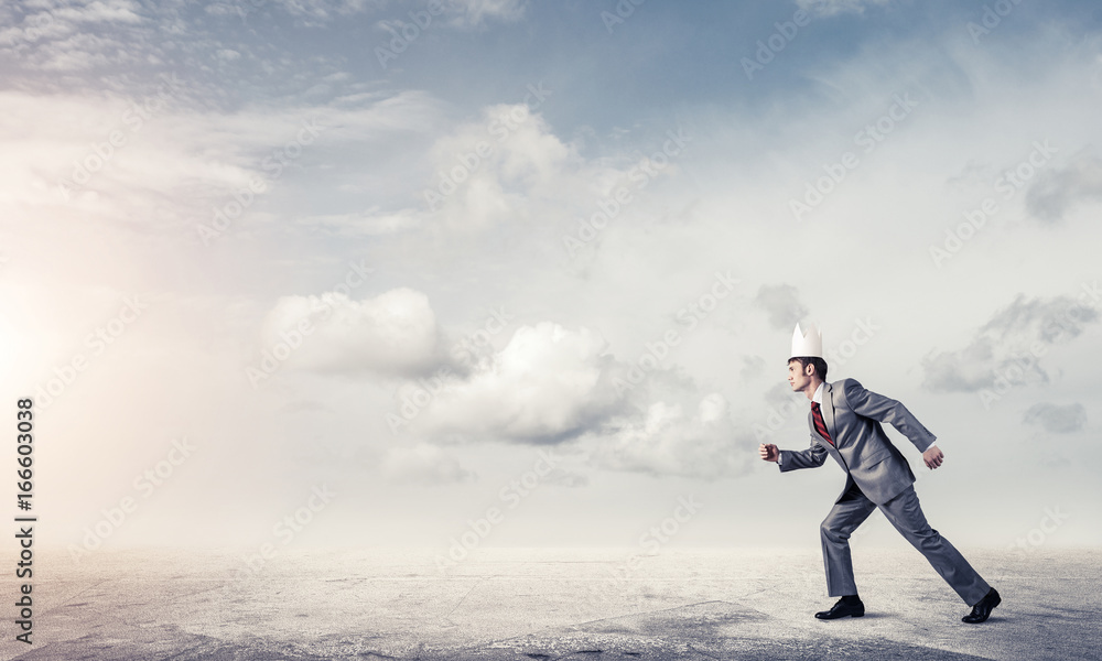 King businessman in elegant suit running and blue sky at backgro