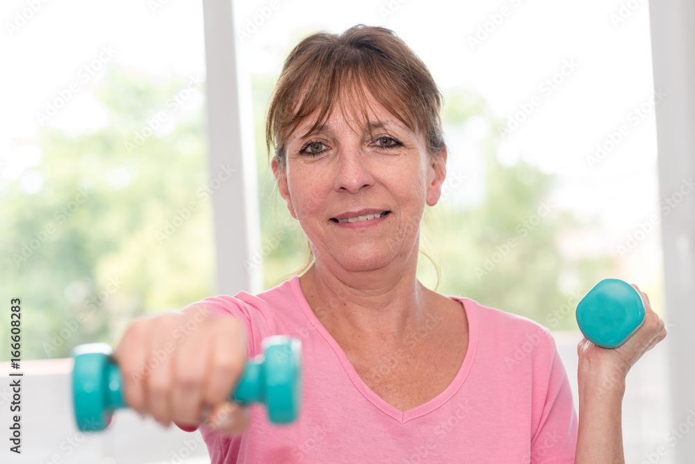 Woman exercising with dumbbells Woman exercising with dumbbells