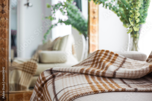 plaid lying on  sofa