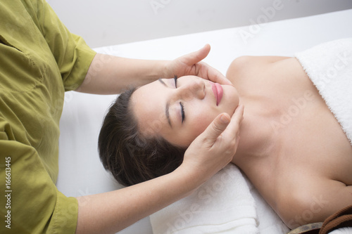 Close up of Beautiful young woman having head or face massage in spa salon wellness  Beauty healthy lifestyle and relaxation concept.
