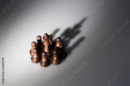 shadow of chess pieces lokk like a king crown photo
