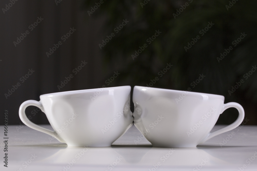 Two white cups on a gray background. I love uou. Two white cups on a gray background. I love uou.