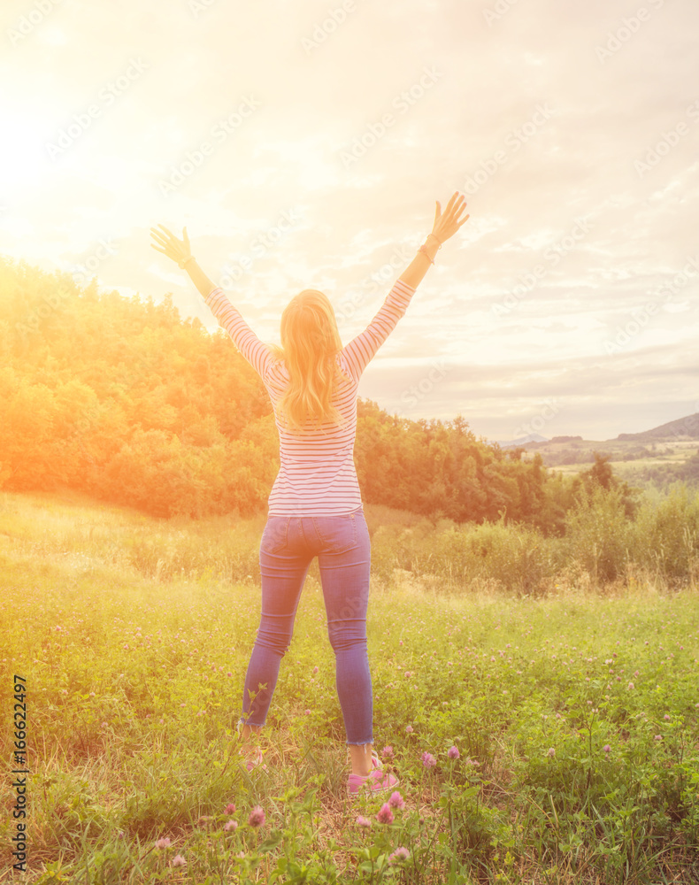 Woman enjoying in the nature with arms wide open. Woman enjoying in the nature with arms wide open.