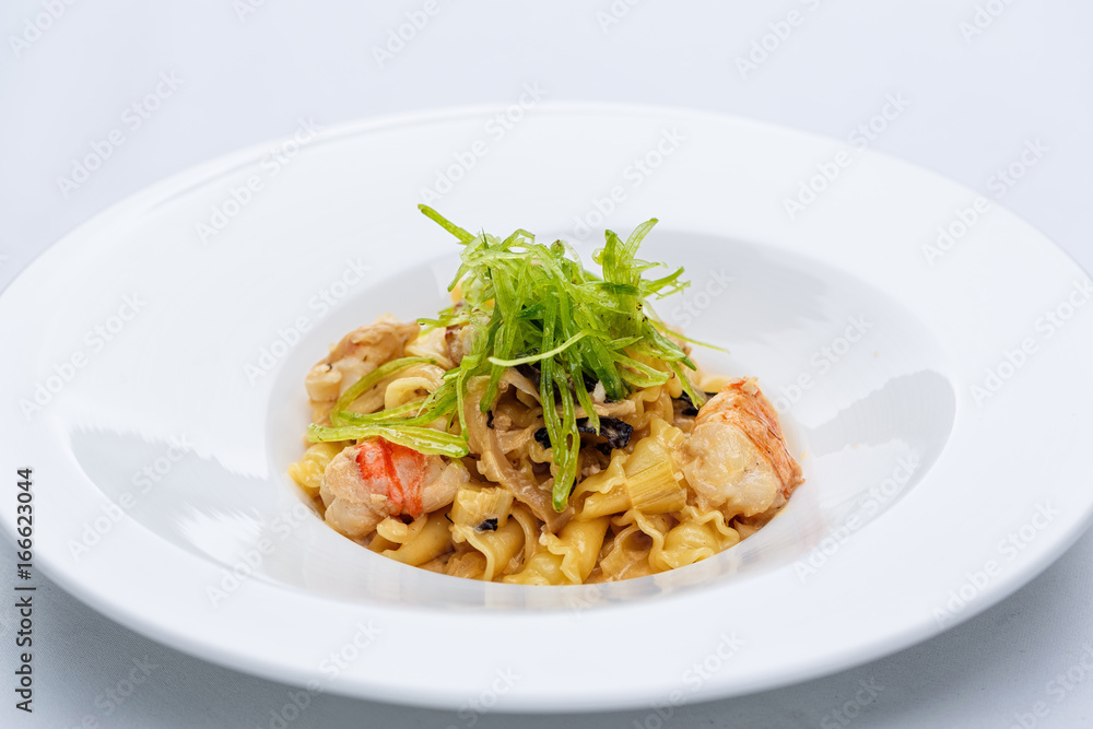 Ballerine pasta with shrimps in white plate Ballerine pasta with shrimps in white plate