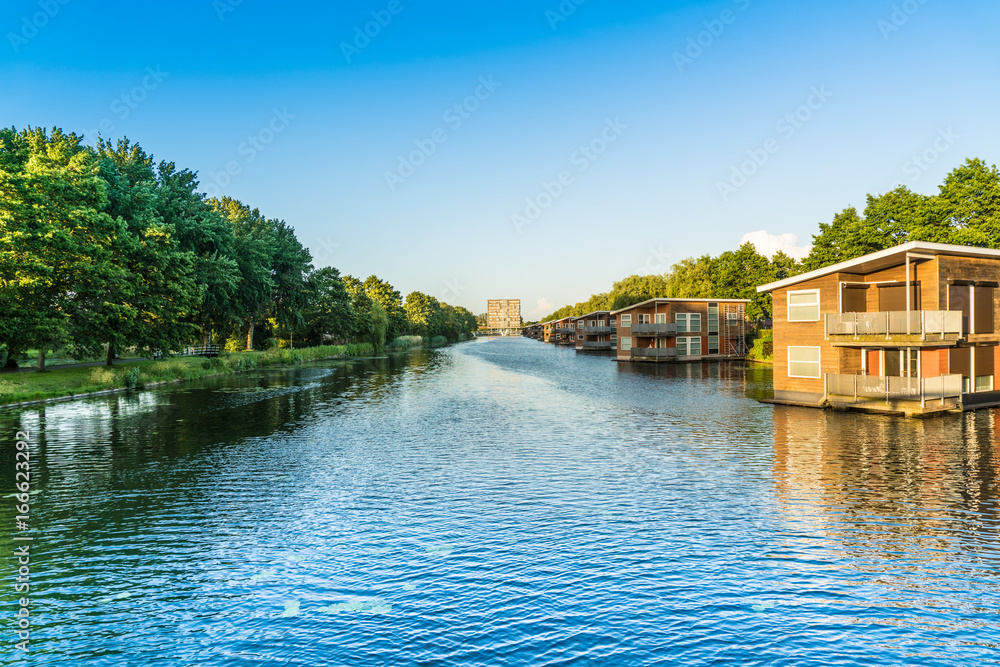 Lelystad, The Netherlands, June 9, 2017: View over Havendiep river looking at appartment building and water houses