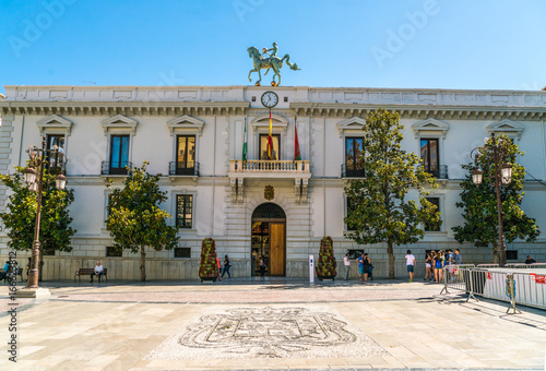 Granada, Spain, juli 1, 2017: Tourists standing in front of the tourist office on Plaza de Carmen photo