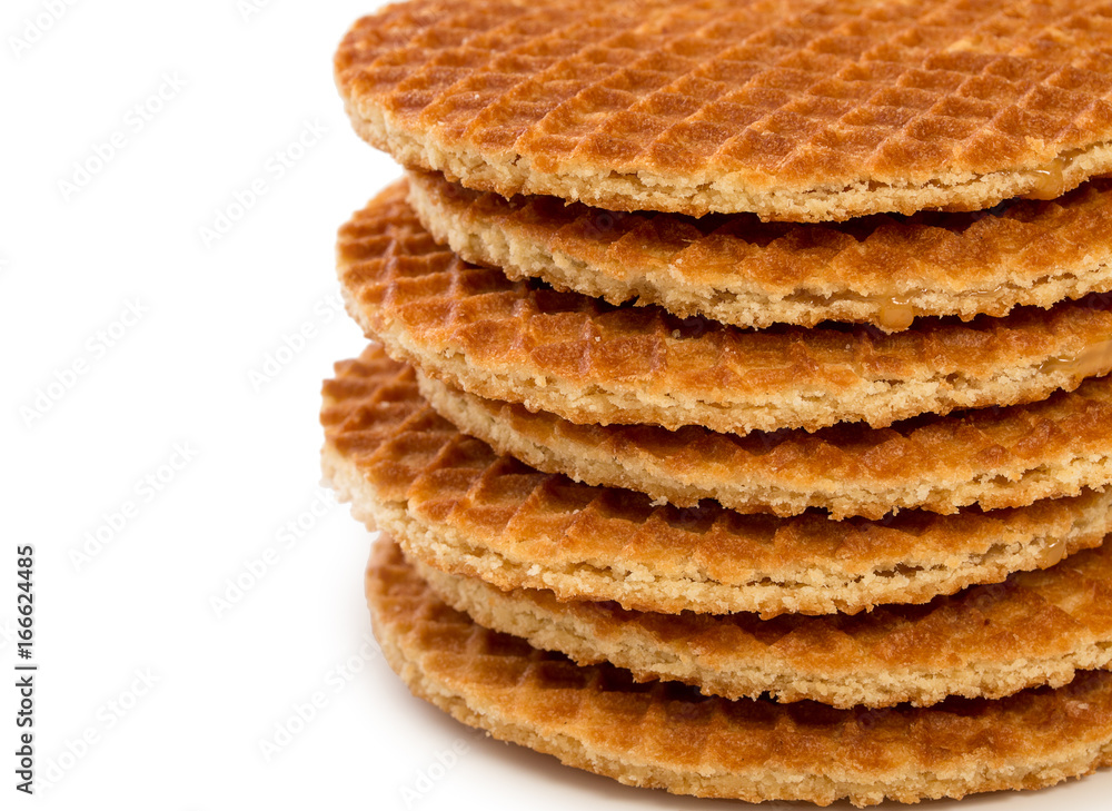 Pile of round dutch waffles with caramel isolated on white background with empty space for your text. Pile of round dutch waffles with caramel isolated on white background with empty space for your text.