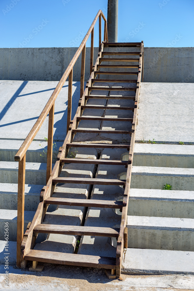 Old wooden stairs outdoors. Steps leading to the sea Old wooden stairs outdoors. Steps leading to the sea