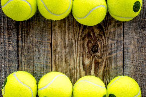 Sport background. Tennis balls on wooden background close up top view copyspace © 9dreamstudio