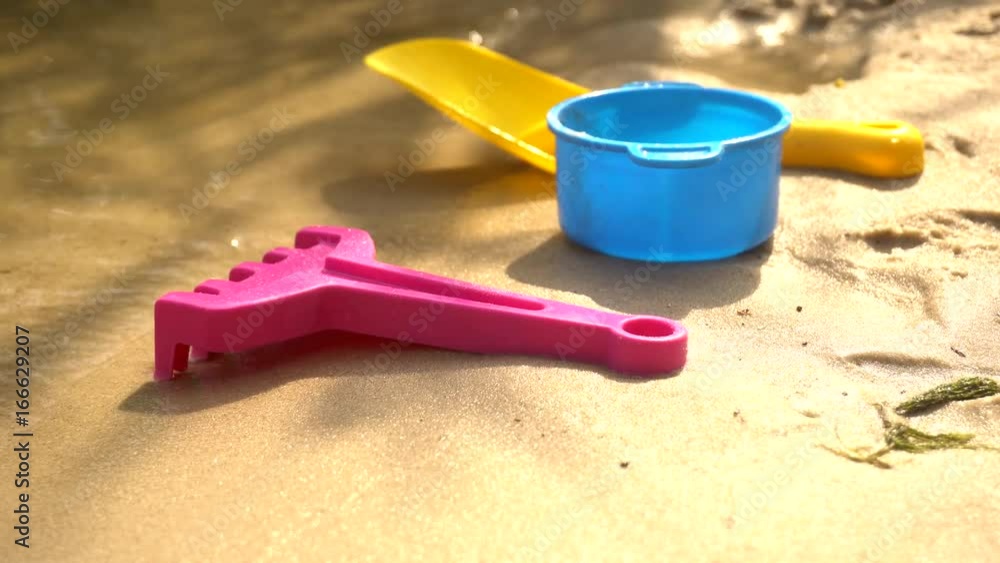 Children's toys on the beach of the lake Children's toys on the beach of the lake