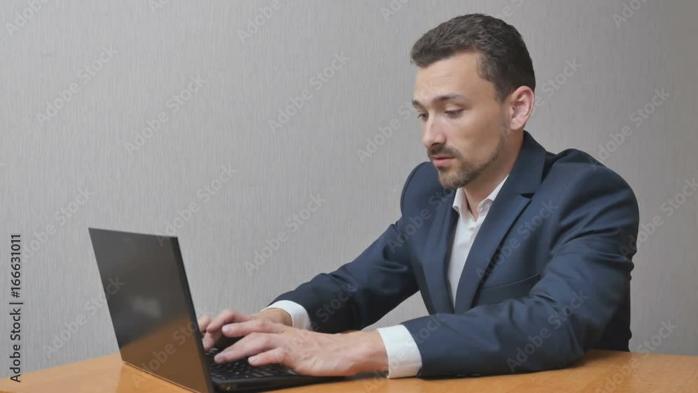 businessman works and has success online. The person joyfully d waves his hand. The man with the laptop is happy. businessman works and has success online. The person joyfully d waves his hand. The man with the laptop is happy.