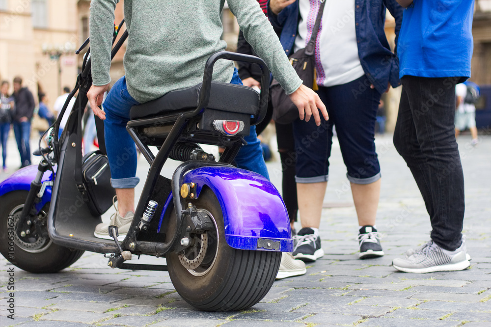 Scrooser Scooter. Young people on electric scooters in the streets of the  city. Photos | Adobe Stock