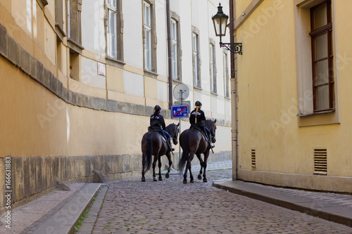 Fotografie, Obraz Prague, Czech Republic - July 27, 2017: Two policewoman on a horseback giving se