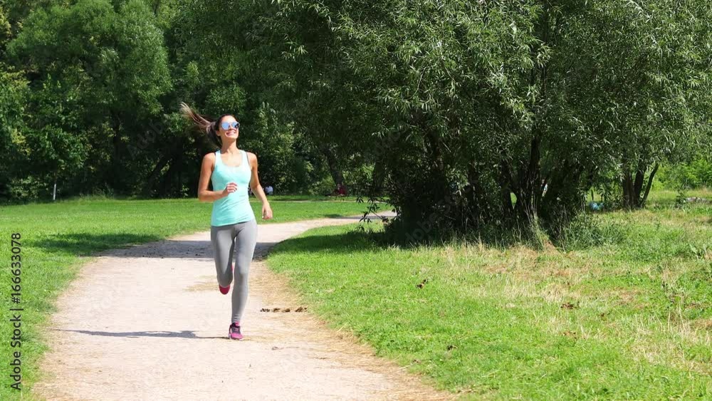Fitness Running Women. Athletic woman working out in a meadow Fitness Running Women. Athletic woman working out in a meadow