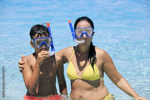 Mother and son snorkeling on the beach