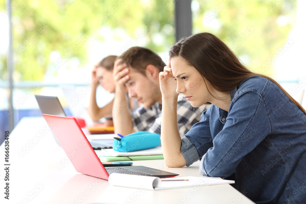 Worried students doing difficult work on line Worried students doing difficult work on line