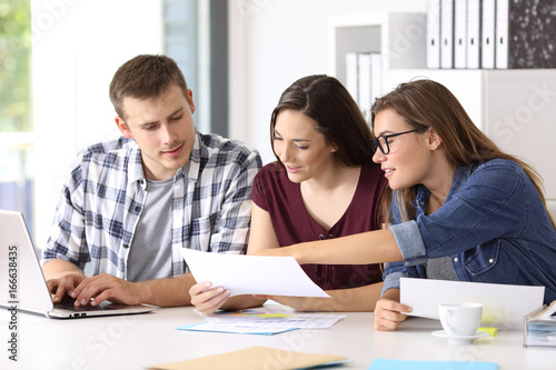 Entrepreneurs analyzing a report at office