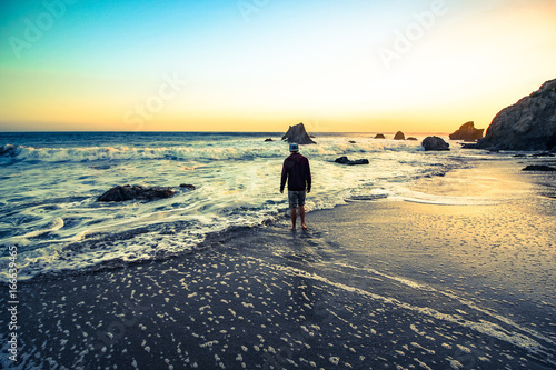 man on the beach at sunset