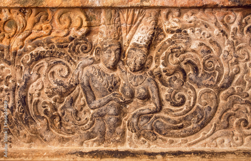 Lovers, two historical people - man and woman - on carved wall relief made in circa 7th century. Artwork inside Hindu temple of Aihole, India Lovers, two historical people - man and woman - on carved wall relief made in circa 7th century. Artwork inside Hindu temple of Aihole, India