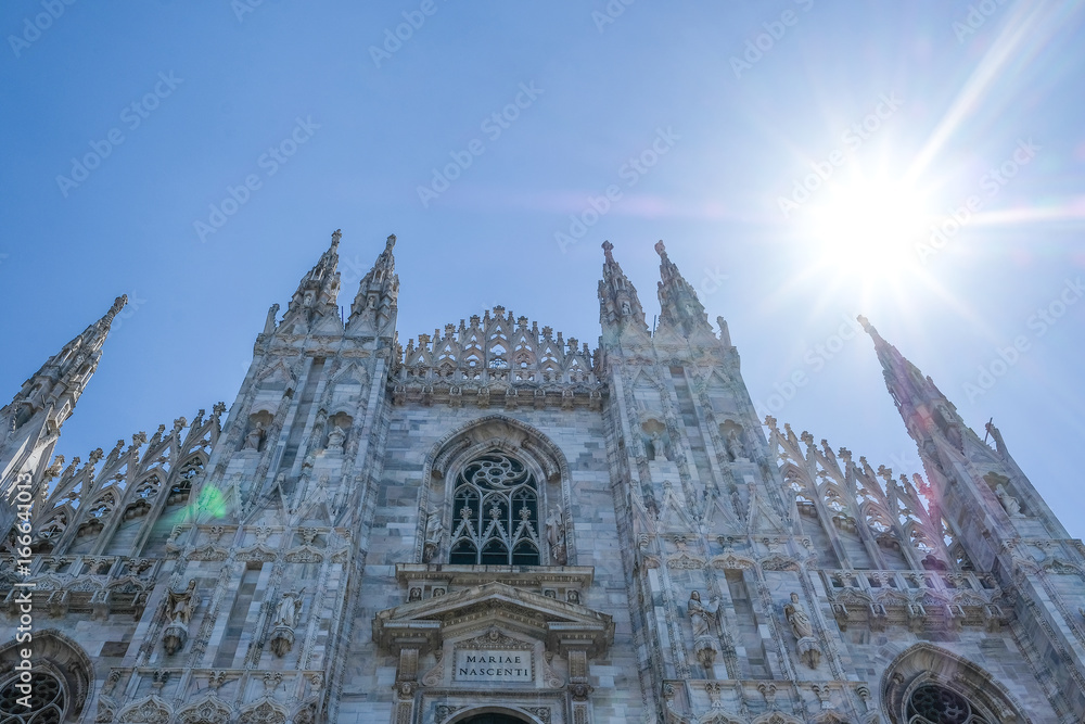 Milan, Italy - June, 16, 2017: Facade of Milan Cathedral - one of the famoust examples of the Italian gothic architecture